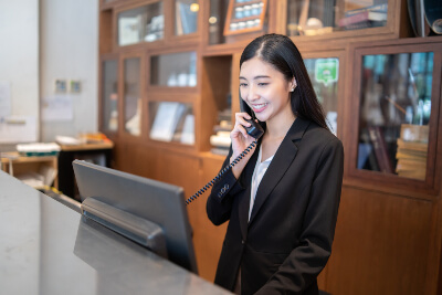 Reception answering the phone in a hotel